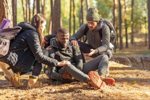 friends-helping-african-injured-guy-while-hiking